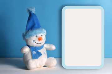 Christmas blank with snowman on a blue background. Greeting card with copy space.