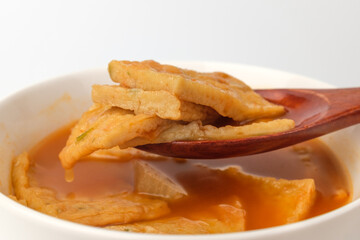 Fish cake soup on a white background