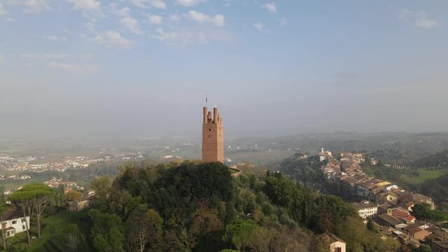 aerial footage of a palace with flags in san miniato in the tuscan province of pisa