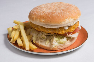 Chicken burger with french fries.