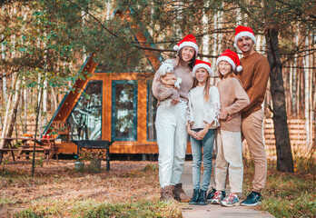 Naklejka na ściany i meble Beautiful family with kids walking at Christmas day