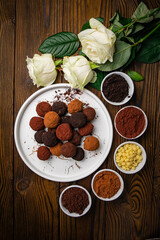 Truffle candies sprinkled with colorful cocoa on a plate
