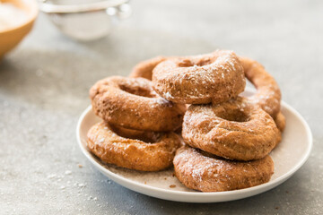 Homemade donuts sugar glazed on a stone background