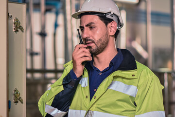 Engineers are using radio communication To coordinate with the team in the production process of...