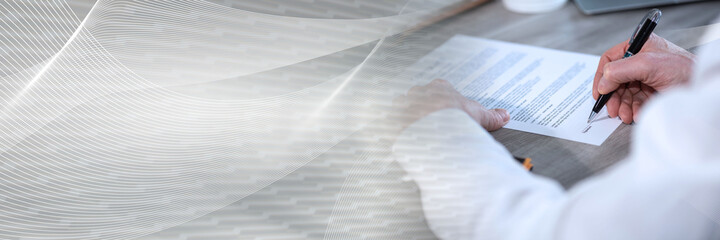Hand of businessman signing a document; panoramic banner