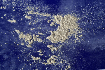 
Scattered white powder on blue background