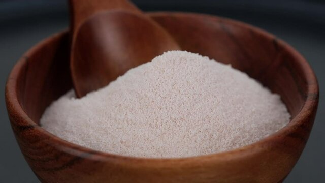 collagen. collagen powder in wooden bowl rotating. Stylish video with collagen. Natural beauty and health supplement