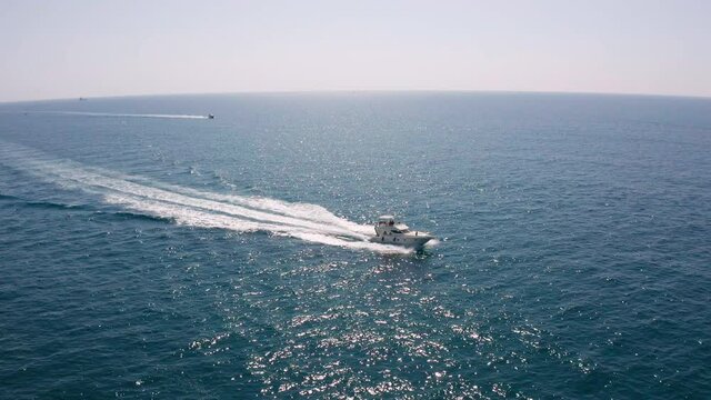 Boat sailing at full speed in the sea, pleasure craft going fast, located in sete, south of france
 