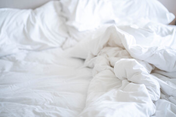 Fototapeta na wymiar Crumpled sheets on bed for background.