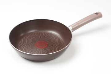Empty frying pan close up on white background