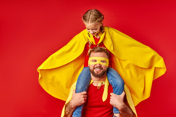 let's fly. funny kid girl and man pretend to be superheroes, male hold little girl on neck, ready...