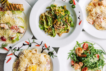 Assorted salads on white plates in a restaurant top view