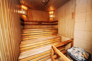 Obraz na płótnie Canvas Sauna steam bath inside with stones and stove