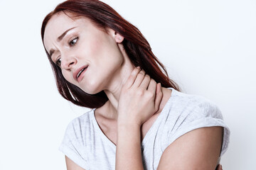  A woman stands and feels a sharp pain in her neck