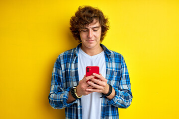 serious teen chatting with girlfriend on mobile phone, communicating on smartphone, typing message