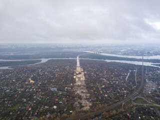 High aerial flight in the clouds over Kiev. An autumn cloudy morning, the Dnieper River and...