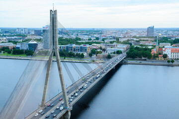 Plakat bridge over the river at sunrise in capital of Latvia - Riga
