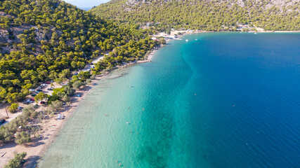 Peloponnese, Greece Aerial view on turqouise blue water and sandy beach. Limni Vouliagmeni or Ireon Lake, 