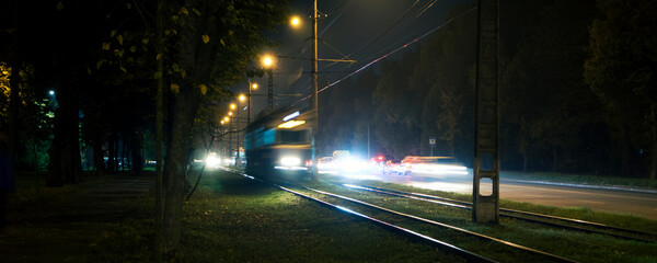The tram rides by railway  in the night city