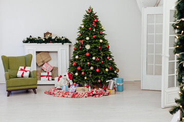 Fototapeta na wymiar Perfect Christmas tree with gifts underneath in living room