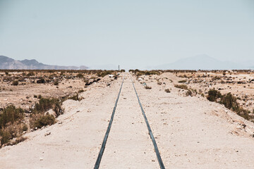 abandoned train tracks in hot desert