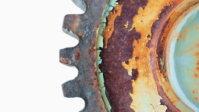 Rotation of an old, rusty cogwheel on a white background.