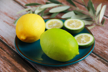 natural yellow lemon and round lemon slices on a decorative plate