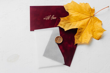 The red velvet envelope is presented on both sides and decorated with a yellow maple leaf. Tracing...