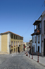 Quiet street with no people passing by on a sunny afternoon in La Orotava, beautiful charming traditional architecture with wooden balconies and old cobblestone road in Tenerife, Canary Islands, Spain