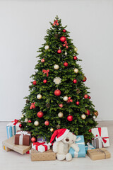 Fototapeta na wymiar Perfect Christmas tree with gifts underneath in living room