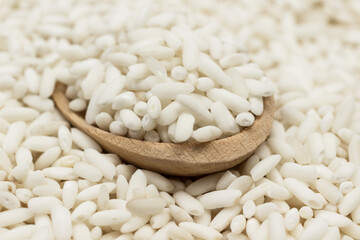 Glutinous rice wooden spoon. Rice on table.