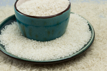 Round white rice in blue cup. Basmati rice on table