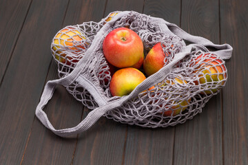 Red apple in reusable cotton mesh bag