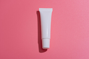 Lip gloss packaging on a pink background. Mockup