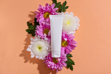 Cream and flower. Conceptual photo: the best cosmetic tool for body and face care. Gentle care. Natural cosmetic product, mockup