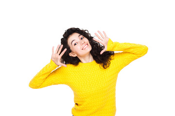 Portrait of beautiful cheerful brunette asian girl with flying curly hair smiling laughing, with hands near her face looking at the camera on a white background