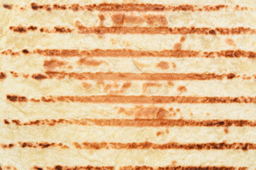 Fototapeta premium Grilled Mexican tortilla on a concrete background. View from above.