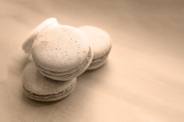 Sweet and delicate macarons on set sail champagne background. French dessert.