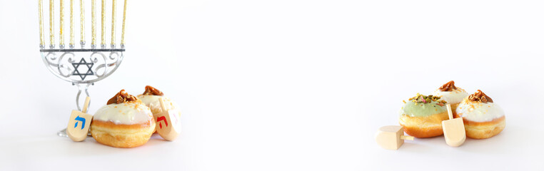 Banner of jewish holiday Hanukkah with doughnut and wooden dreidels (spinning top)