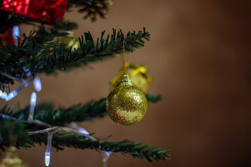 Decorated Christmas tree. Christmas toys close up. Holiday decorations. Golden christmas ball