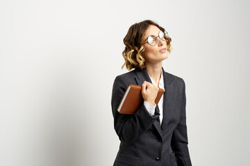 business woman in a suit with documents in hands light background curly hair hairstyle