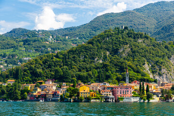 Spectacular view of Italian city of Varenna at foot of mountain on shore of Lake Como overlooking bell tower of Church of San Giorgio, Lombardy