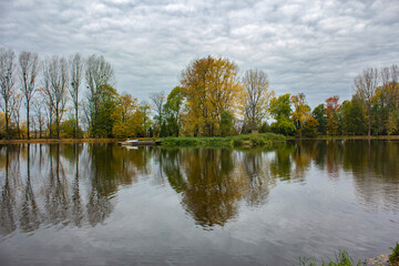 Landscape, view of the lake and trees, cloudy sky, overcast.