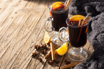 Traditional mulled wine with spices on rustic wooden table.Copy space