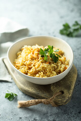 Homemade spicy rice with carrot and fresh parsley