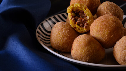 Arancini, Italian street food made of rice, meat and vegetables .