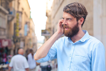 young man talking on the phone on the street