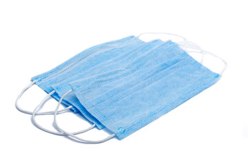 Three blue disposable surgical surgeon face masks prevent spread of corona virus covid-19 on white background