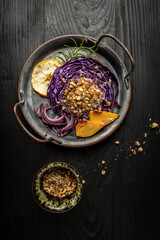 Traditional German dish of red cabbage baked with nuts, quince and apples, chef cooking autumn dish of red cabbage baked