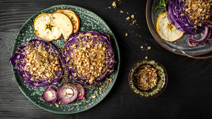 Autumn dish of red cabbage baked with nuts, quince and apples, Vegan roasted red cabbage steaks, Food recipe background. Close up